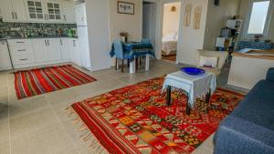 a living room with a table and a kitchen at Mimas Home in Hisarcık