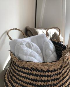 a basket filled with towels in a room at Latea luxury apartment in Lukavica