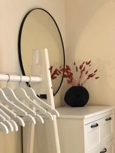 a mirror sitting on top of a white dresser at Latea luxury apartment in Lukavica