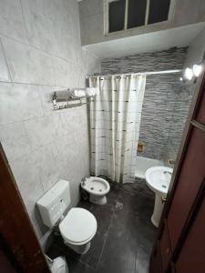 a bathroom with a toilet and a sink at El pasillo Centro in Rosario