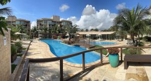 a view of a pool from a balcony of a resort at Palm Beach Residence in Aquiraz