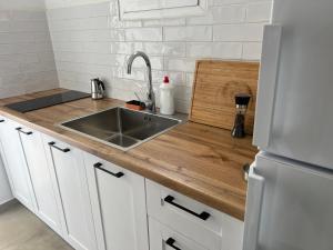 a kitchen with a sink and a wooden counter top at Villa Calliope in Himare