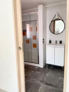 a bathroom with a shower and a sink and a mirror at Casa da Tia in Sesimbra