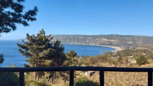a view of the ocean from a balcony at Cabañas & SPA Carilafquen in Laguna Verde