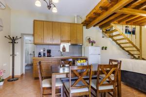 a kitchen and dining room with a table and chairs at Villa Nirvana in Skopelos Town
