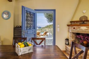 a dining room with a door leading to a patio at Villa Nirvana in Skopelos Town