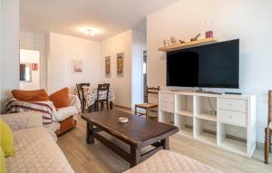 a living room with a tv and a couch and a table at Gorgeous Apartment In Malaga With House Sea View in Málaga