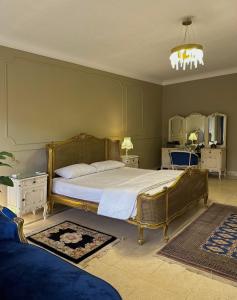 1 dormitorio con 1 cama con marco dorado en Spacious, Luxurious 3-Bedroom Apartment in Nasr City for Families & Corporates, en El Cairo