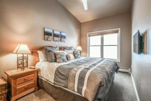 a bedroom with a large bed and a window at Hidden River Lodge 5981 in Keystone