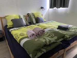 a bed with two towels on top of it at Hillside Strašín Šumava in Strašín