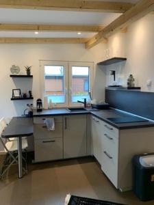 a kitchen with a sink and a counter top at CARLA AM STRAND in Garrel