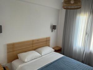 a bedroom with a white bed and a window at Villa Calliope in Himare