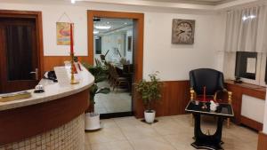 a lobby of a salon with a counter and chairs at Parkhotel Goldlinde in Bodenwerder