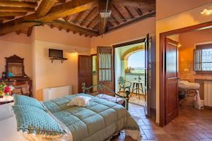 a bedroom with a bed and a table in a room at Corte Delle Stelle in Cortona