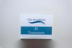 a sign on a wall with the number tramwegian at APPARTEMENT TRAUMSTERN 21 - zum Strand wenige Geh Minuten in Baabe