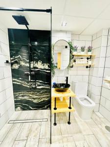 a bathroom with a shower and a sink and a toilet at Apartament Bella Vista in Los Nietos