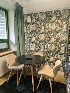 a dining room with a table and two chairs at Apartament Zegrzyński z widokiem in Serock