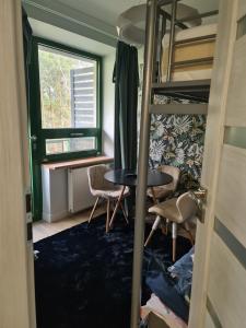 a bedroom with a desk and bunk beds at Apartament Zegrzyński z widokiem in Serock