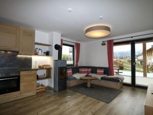 a living room with a couch and a table at Chalet Alpenzauber, Inzell in Inzell