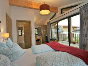 a bedroom with a bed and a large window at Chalet Alpenzauber, Inzell in Inzell