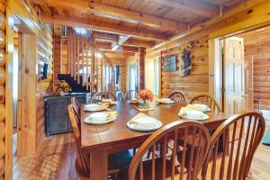 a dining room with a wooden table and chairs at Lovely Gatlinburg Cabin with Private Hot Tub! in Gatlinburg