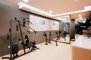 a gym with treadmills and elliptical machines at Depto nuevo Full equipado - Estacionamiento - Plaza Egaña, Ñuñoa in Santiago