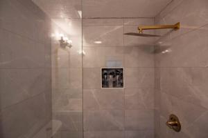 een badkamer met een douche en een glazen deur bij Butler Street Escape - Apt 1 in Pittsburgh