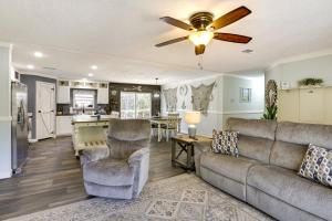 a living room with a couch and a ceiling fan at Charming Perry Home about 2 Mi to the Gulf! in Perry