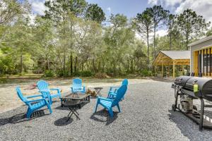 a group of chairs and a grill on a gravel patio at Charming Perry Home about 2 Mi to the Gulf! in Perry