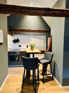 a kitchen with a table and two chairs at Ferienhaus Rost in Volkach