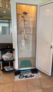 a shower in a room with a glass door at Athens Victoria's Apartment in Athens