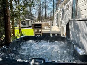 a hot tub in the backyard of a house at Leaf Lane Lodge in Newton on the Moor