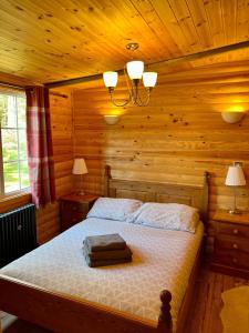 a bedroom with a bed in a log cabin at Eagle Lodge in Newton on the Moor