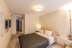 a bedroom with a bed and a television in it at Calanthe Residence in Istanbul