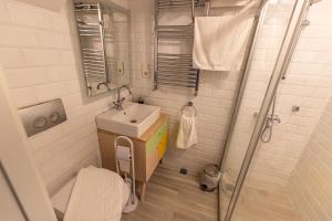 a small bathroom with a sink and a shower at Calanthe Residence in Istanbul