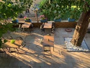 a patio with tables and chairs and a tree at Burgfreiheit in Heidelberg
