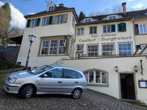 a silver car parked in front of a building at Burgfreiheit in Heidelberg +4 photos