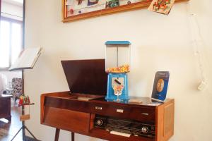 a wooden dresser with a tv on top of it at Buen Aire in Cagliari