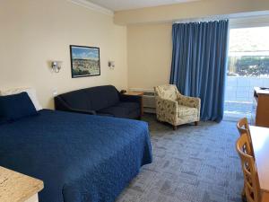 a hotel room with a bed and a couch at Courtyard Resort in Hyannis