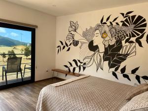 a bedroom with a wall mural of a woman at Palta 60 Valle de Guadalupe in Valle de Guadalupe