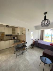 a kitchen and a bedroom with a bed and a table at Cozy Coral Bay Studio by the sea in Coral Bay