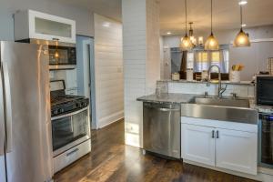 a kitchen with stainless steel appliances and a sink at Milwaukee Vacation Rental - 2 Mi to Dineen Park! in Milwaukee