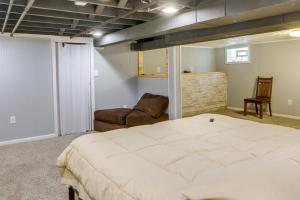 a bedroom with a large bed and a couch at Milwaukee Vacation Rental - 2 Mi to Dineen Park! in Milwaukee