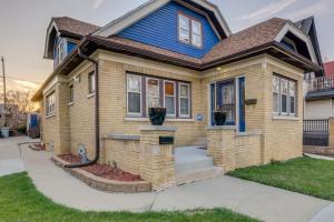 a brown house with a blue roof at Milwaukee Vacation Rental - 2 Mi to Dineen Park! in Milwaukee