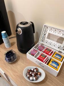 a table with a tea kettle and a box of food at Casa Michele in Ercolano