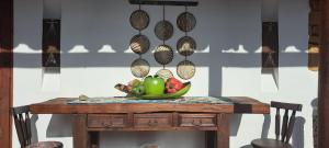 a table with a bowl of fruit on top of it at Casa Tierrarte in Barichara