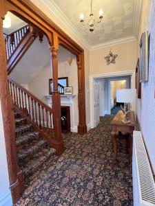 a hallway with a staircase in a house at Forest Side Guesthouse in Lyndhurst