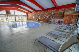 a large room with a swimming pool in a building at Courtyard Resort in Hyannis