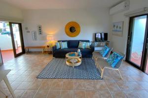 a living room with a blue couch and chairs at KASA Rio Mar Villa for 2 in Rio Grande