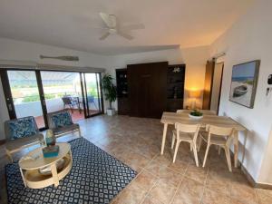 a living room with a table and chairs and a dining room at KASA Rio Mar Villa for 2 in Rio Grande